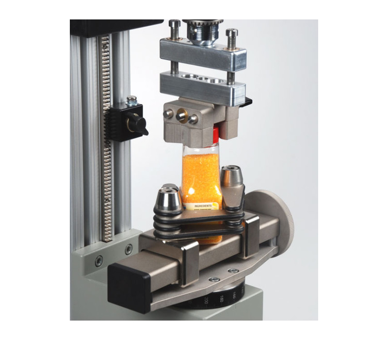 G1053 en combinación con un compensador axial AC1029 utilizado en un ensayo de torsión de tapón de botella